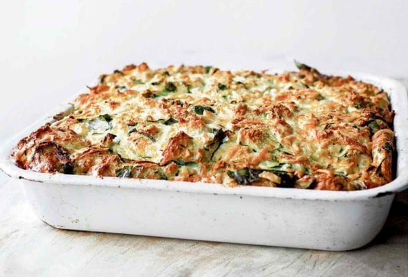 A white baking dish filled with zucchini strata
