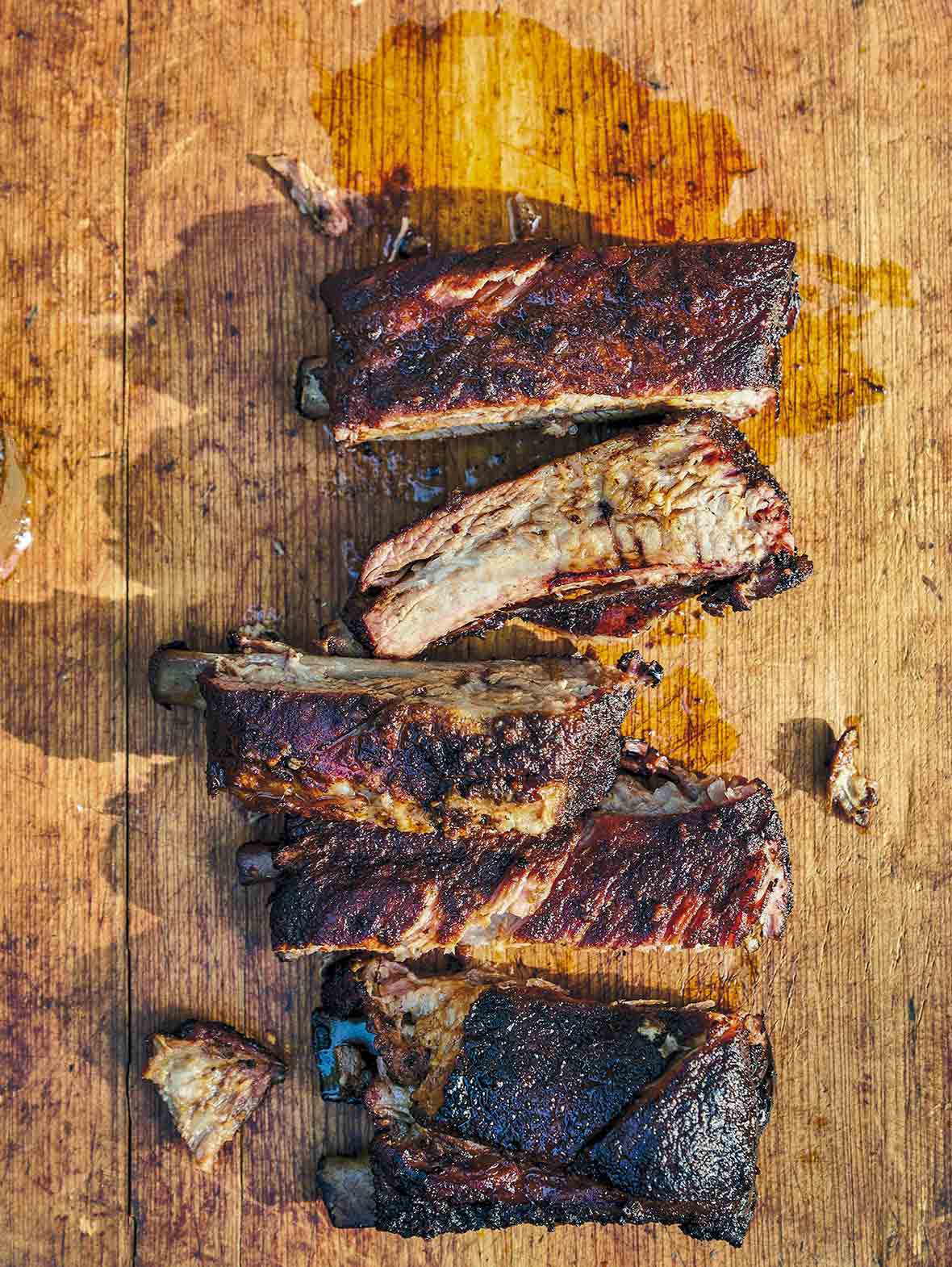 A wooden board with five cut Memphis-style ribs