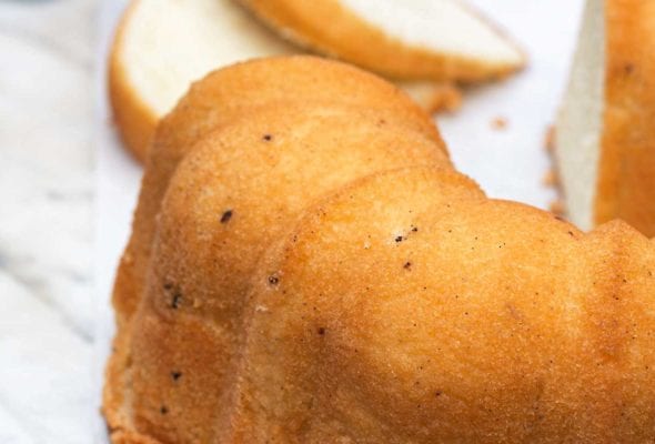 A vanilla pound cake, cut, on a marble slab