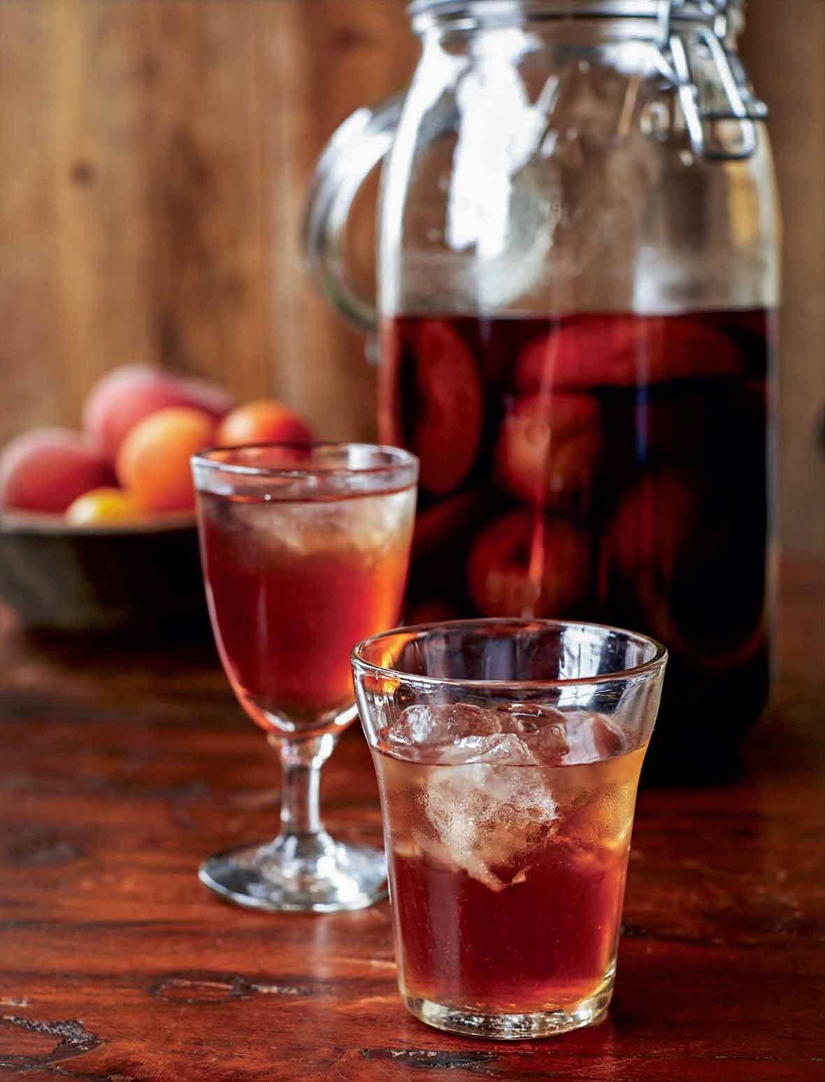 Two glasses of bachelor's jam liqueur with a large jar of bachelor's jam in the background.