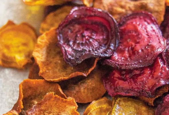 A pile of beet and sweet potato root vegetable chips.