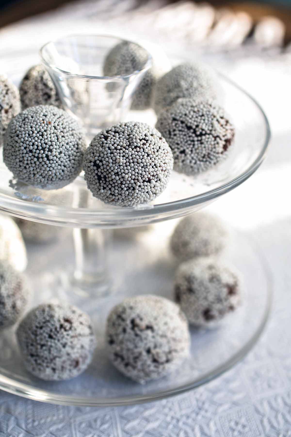 A two-tiered platter with rum balls on each tier