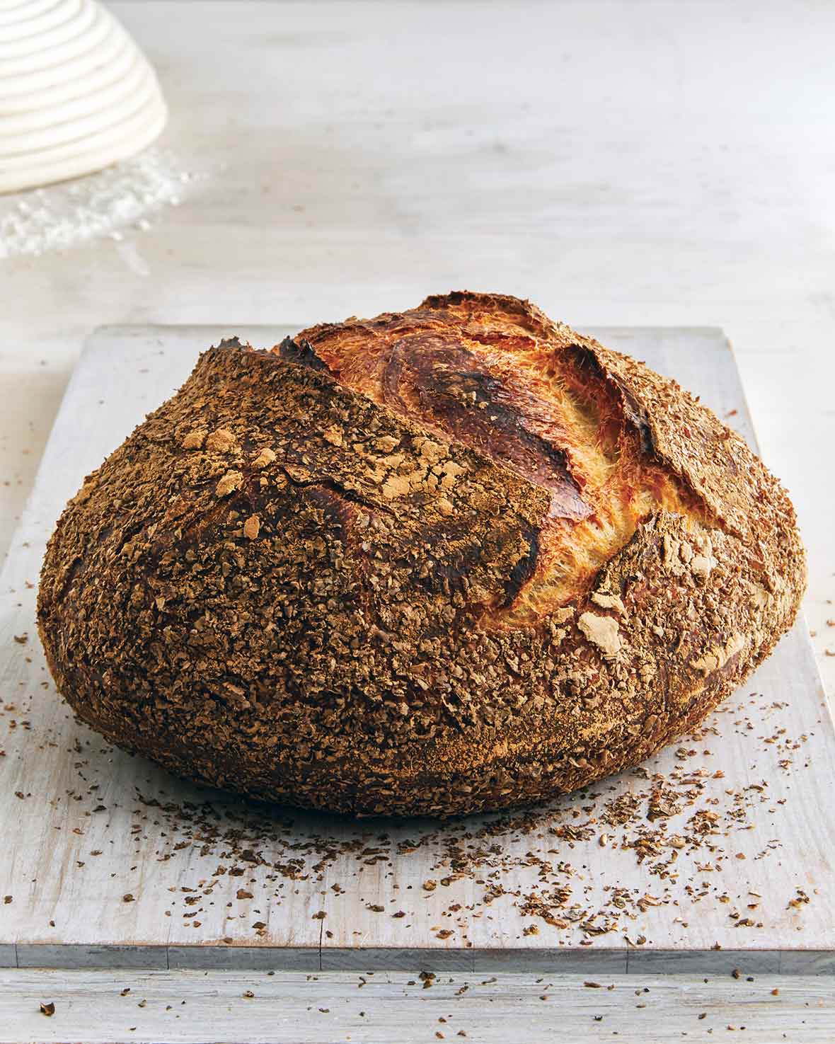 A loaf of pane bianco on a white wooden board.