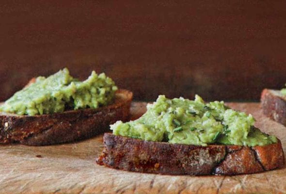 Three pieces of bread topped with fava bean puree.