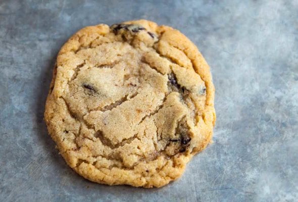 A small batch of chocolate chip cookies on a baking sheet.