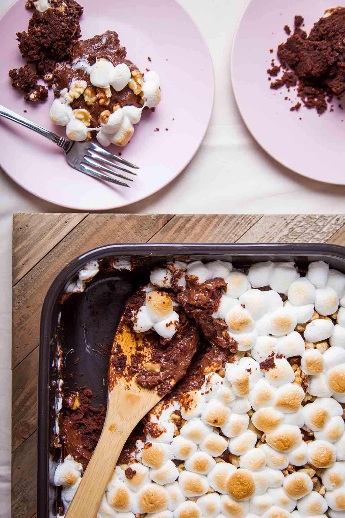A square pan and two plates filled with Mississippi mud cake.