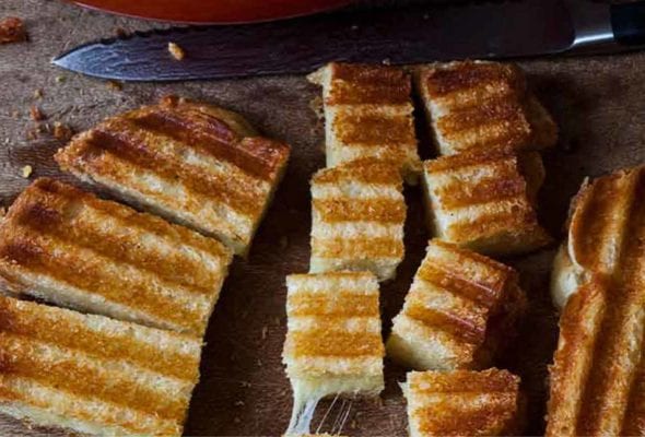 A grilled cheese sandwich cut into cubes of grilled cheese croutons.