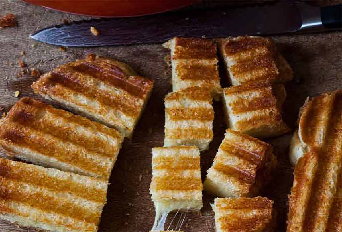 A grilled cheese sandwich cut into cubes of grilled cheese croutons.