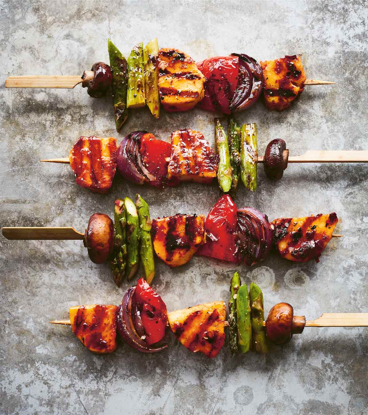 Four grilled vegetable skewers with harissa-marinated halloumi.