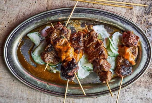 Catalan lamb skewers on sliced cucumbers topped with a romesco sauce