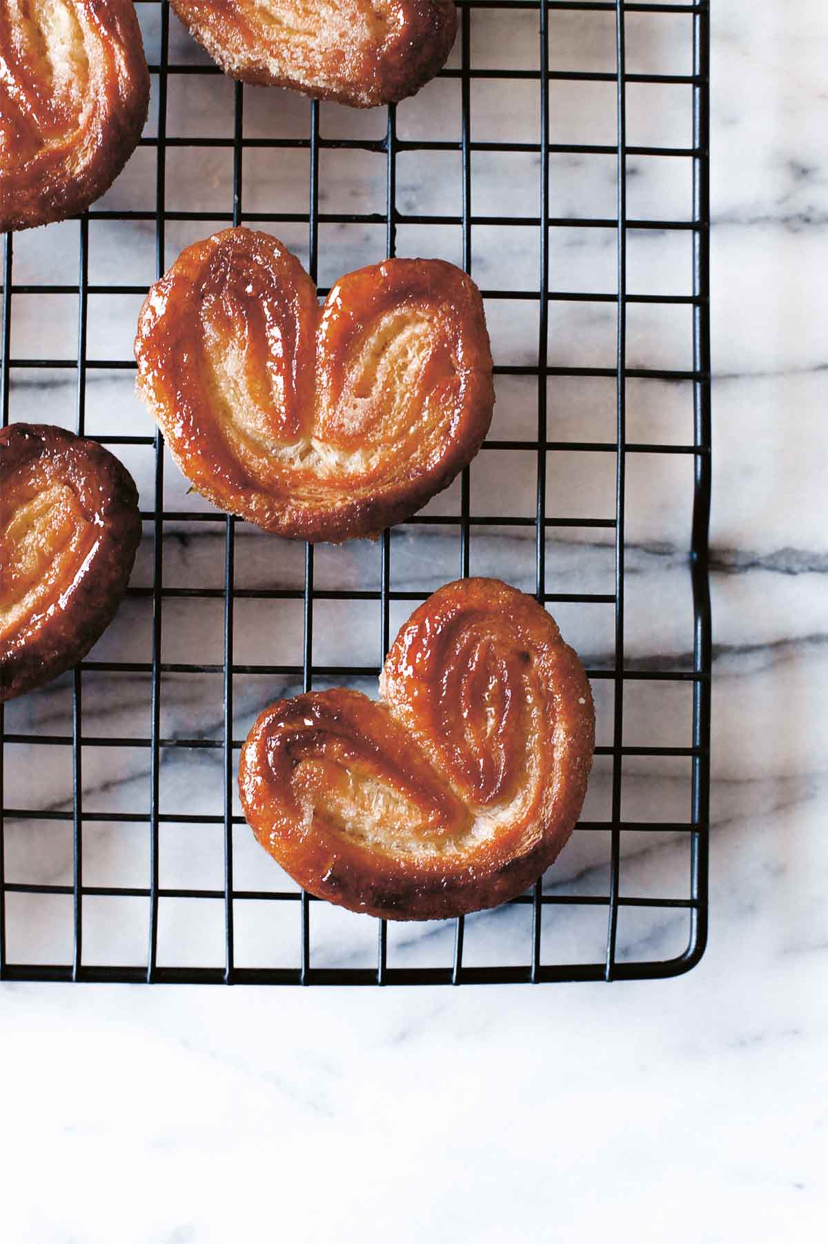Several palmiers on a wire rack.