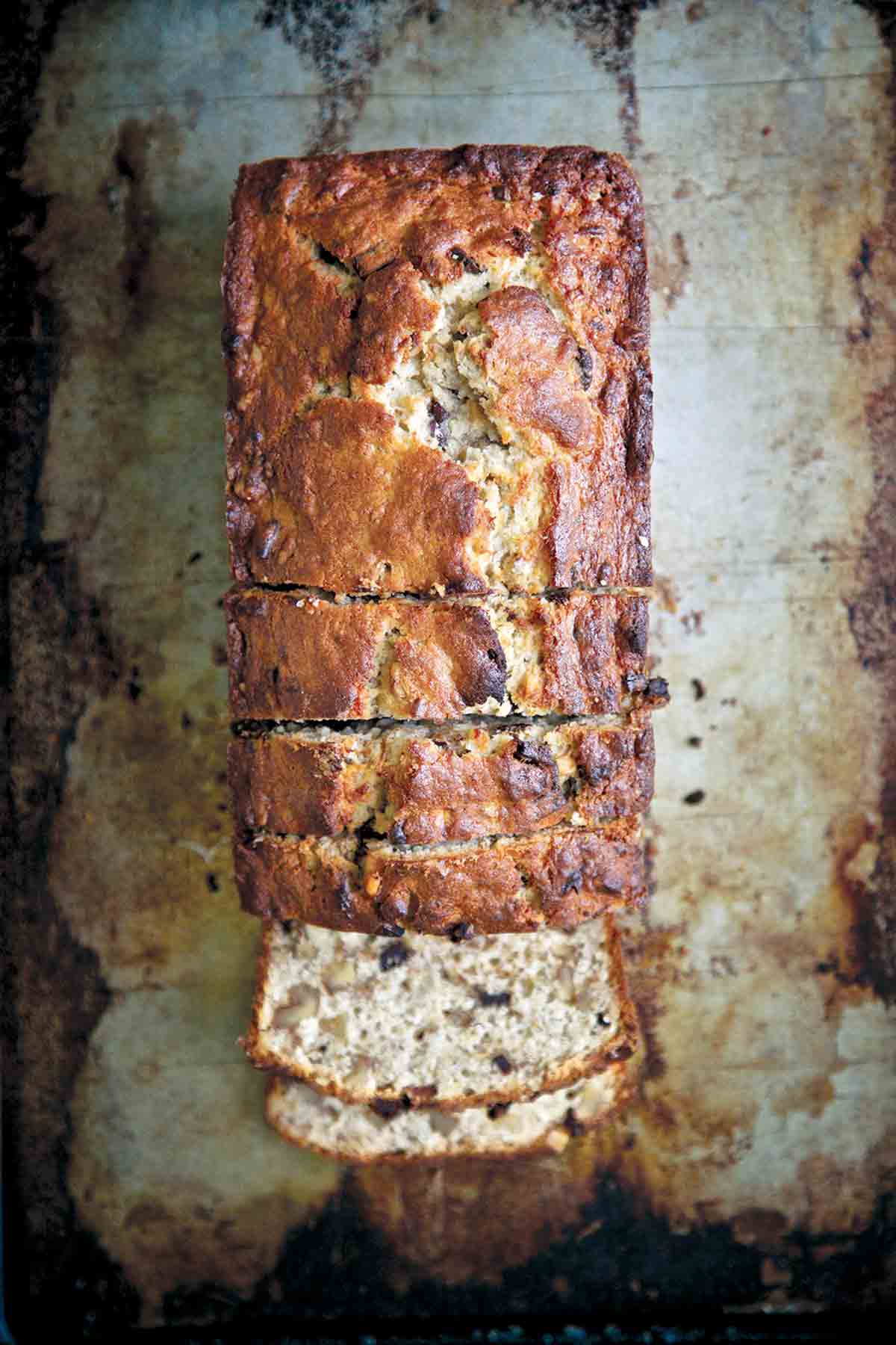 A loaf of chocolate-bourbon banana bread with several slices cut off one end.Chocolate Bourbon-Spiked Banana Bread