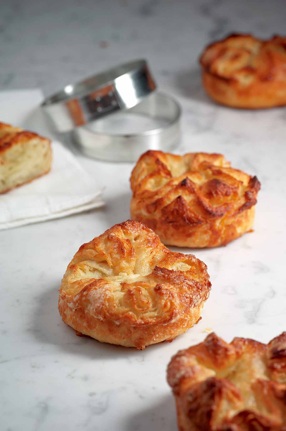 Five koiugn amman--puff pastry coated with sugar--on white marble