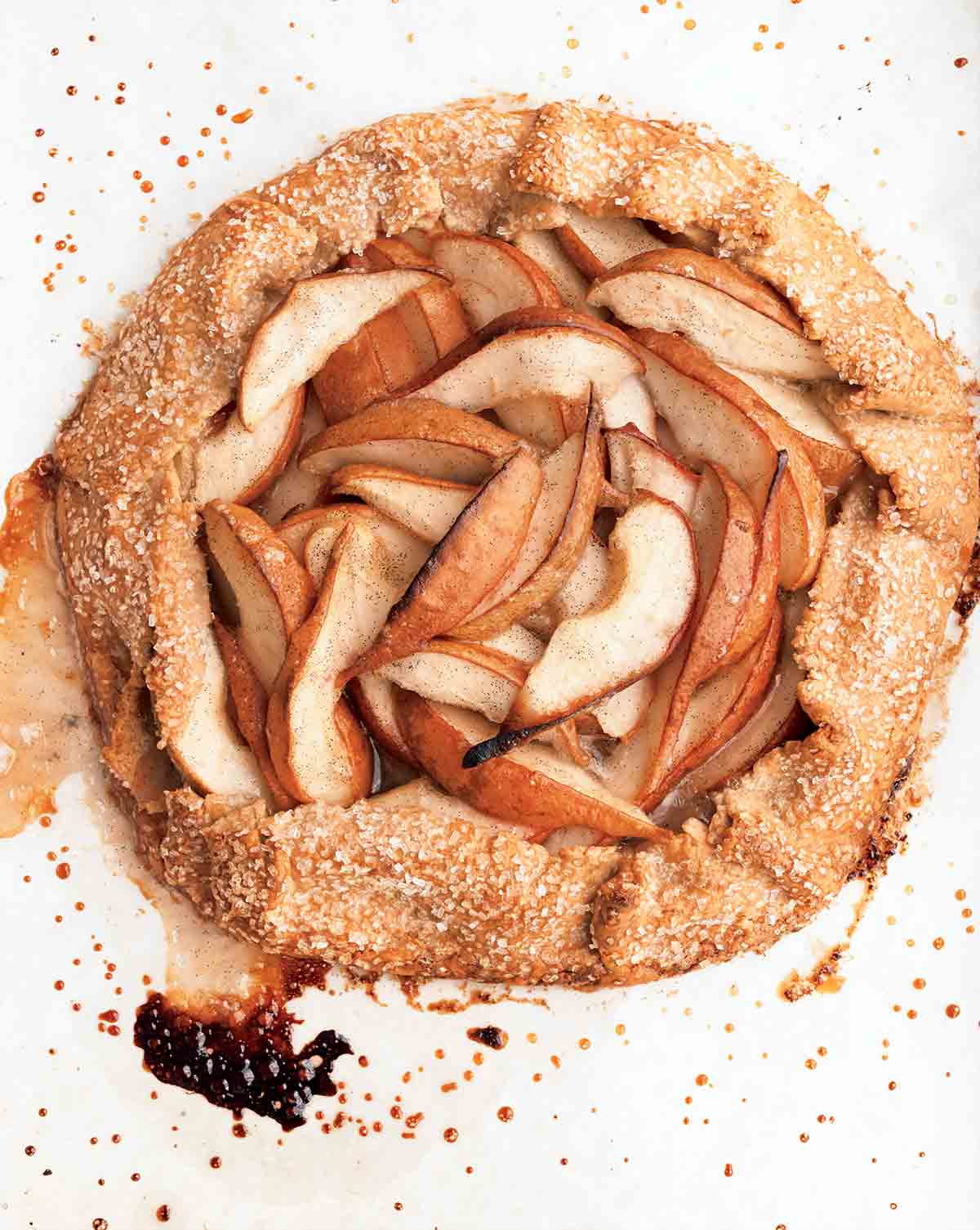 A baked pear galette on a white surface.