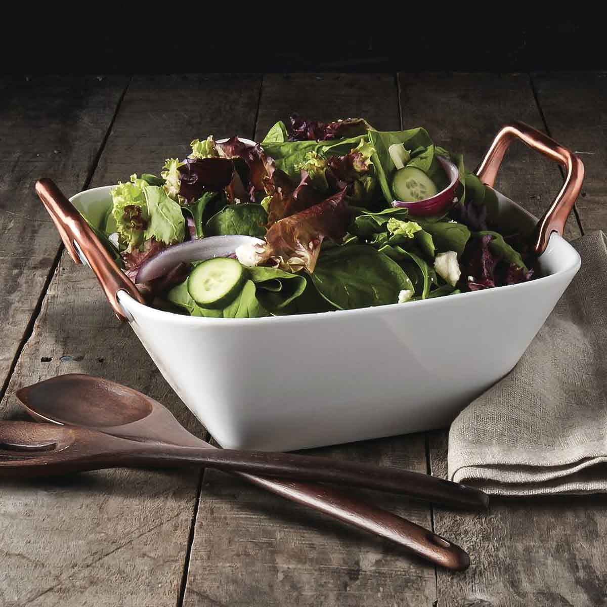 Romford Square Serving Bowl shown with salad on wood table with wood serving utensils.
