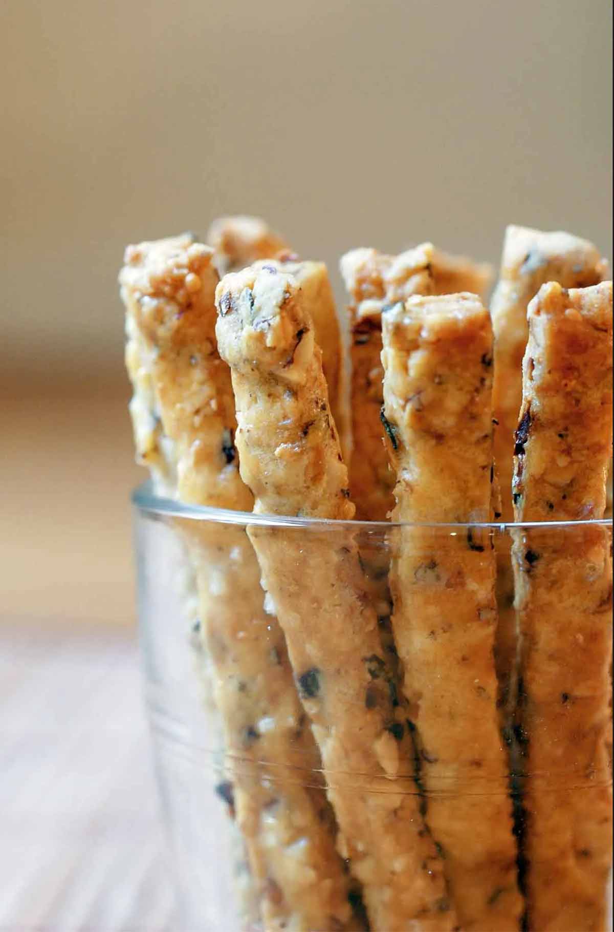A glass with a dozen hazelnut thyme matchsticks